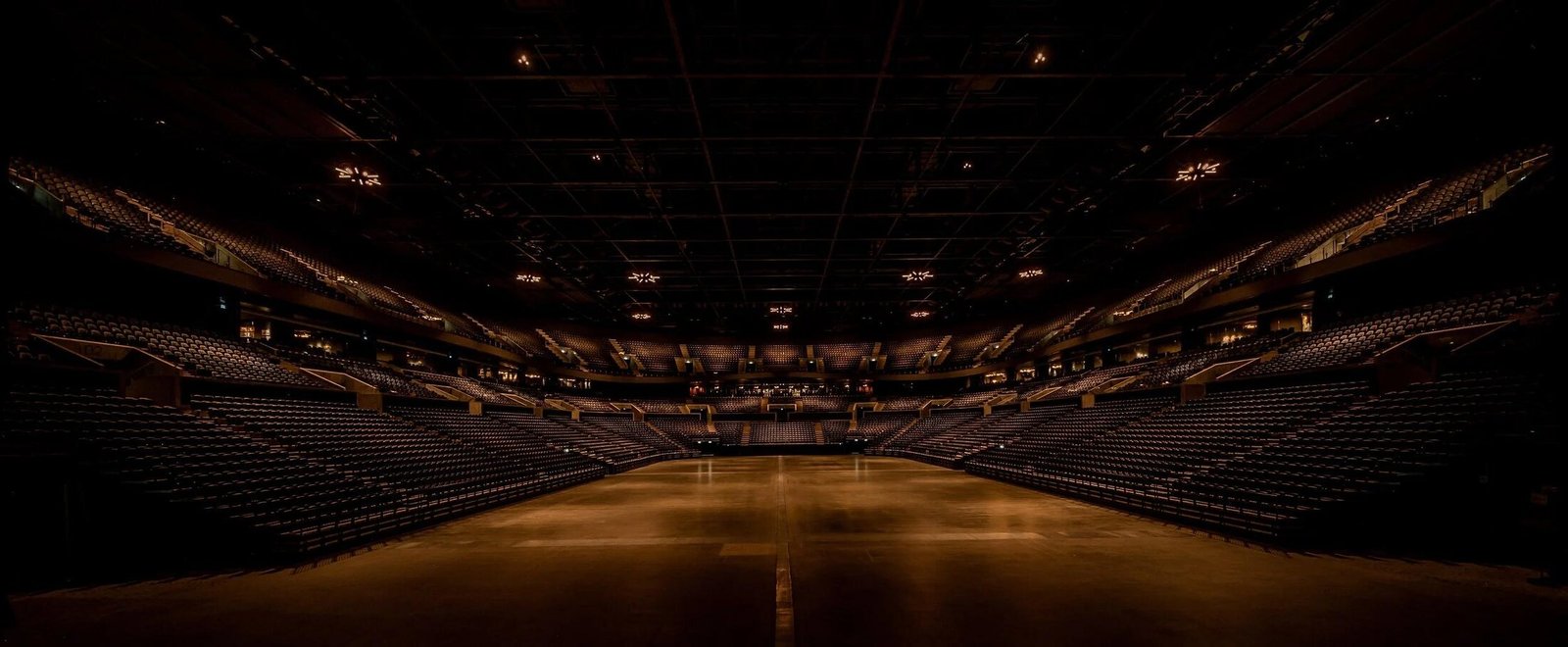 Empty arena bathed in warm light before a live event
