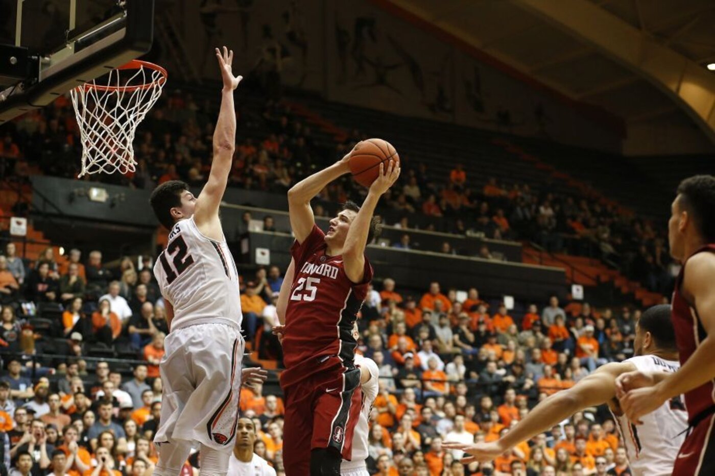 Live basketball game action in front of a packed arena crowd
