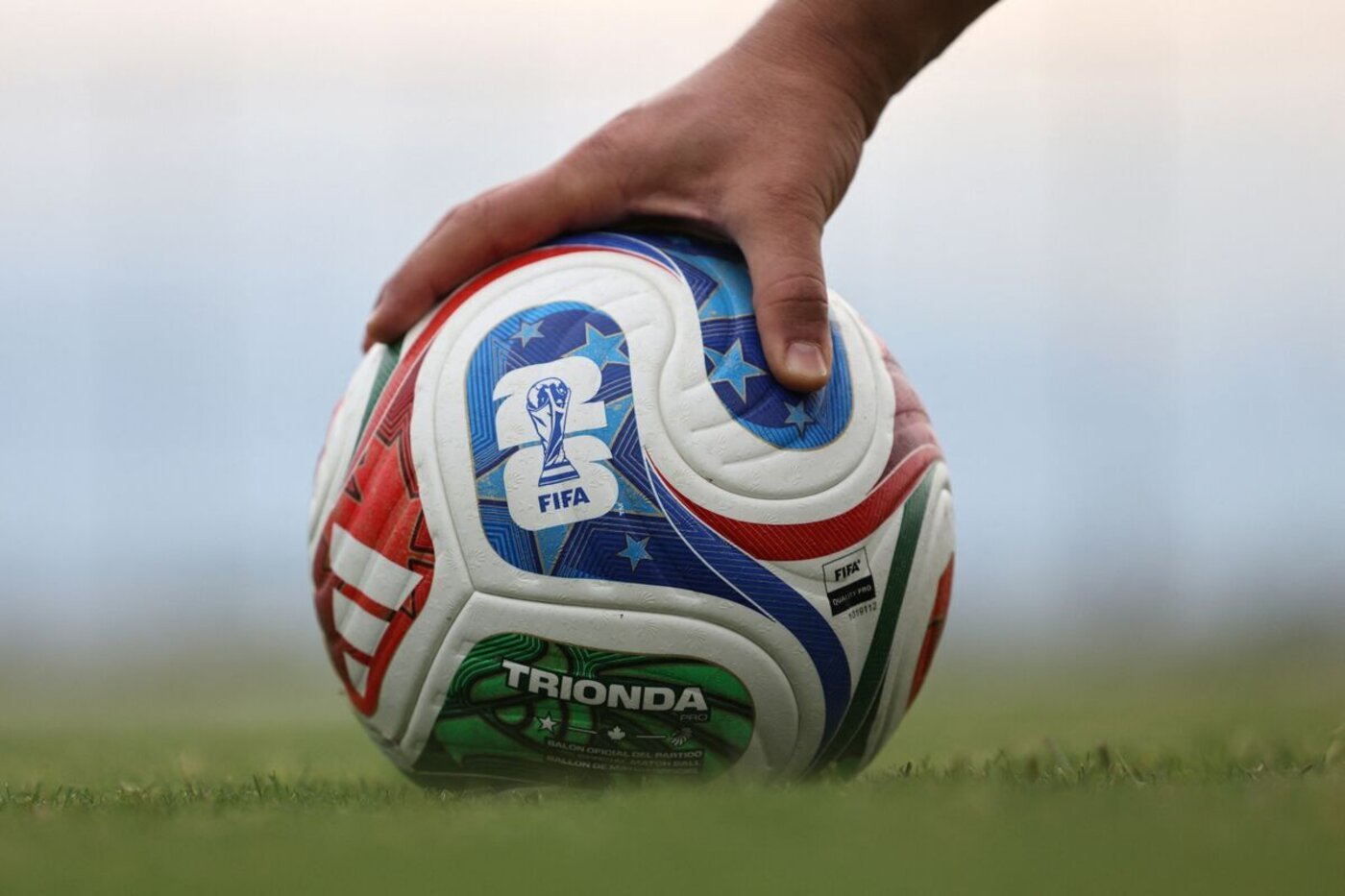Close-up of an official match ball on the pitch, ready for kickoff