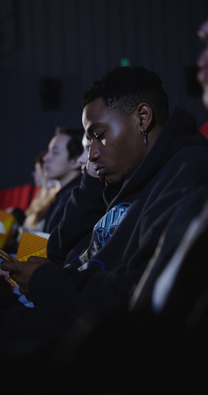 Audience watching a film together in a dark cinema